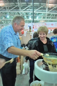 Making Fribourg-style Swiss fondue at Swiss Slow Food stand, Slow Food Salone del Gusto 2012, Turin, Italy